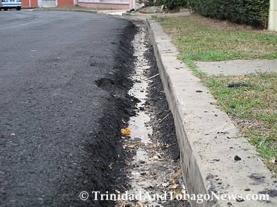 On the other side of the street the edge of the newly paved road has also created a deep slipper drain that cars can slip into thereby causing drivers to lose control.