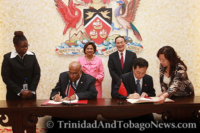 Trinidad and Tobago's Prime Minister Kamla Persad-Bissessar (rear left) and Chinese Vice Premier Wang Qishan (rear right) attend a signing ceremony for an intergovernmental agreement between the two countries at the Diplomatic Centre in St. Ann's Port of Spain, Trinidad and Tobago, on Monday, September 12, 2011.