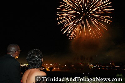 Minister of Arts and Multiculturalism Winston 'Gypsy' Peters and Prime Minister Kamla Persad-Bissessar observe the Independence fireworks display from the Hilton rooftop