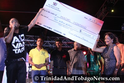 Machel Montano receives Soca Monarch $2 Million Cheque from PM Kamla Persad-Bissessar at Girl Power Fete