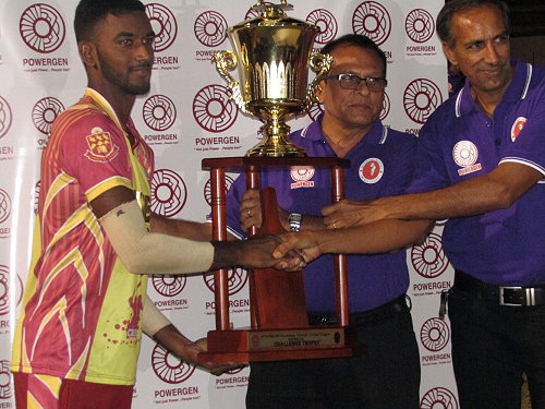 HVC Skipper Navin Bidaissie (left) Receiving the Championship Trophy from Powergen and Secondary Schools Officials after the match