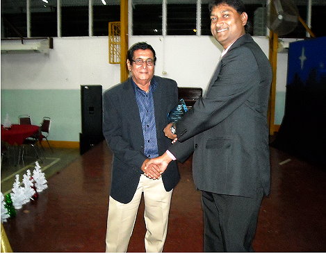 Ramlogan Mahabir (left) Receiving his Plaque from The President of the Hillview Old Boys Association, Mr.Peter Machikan