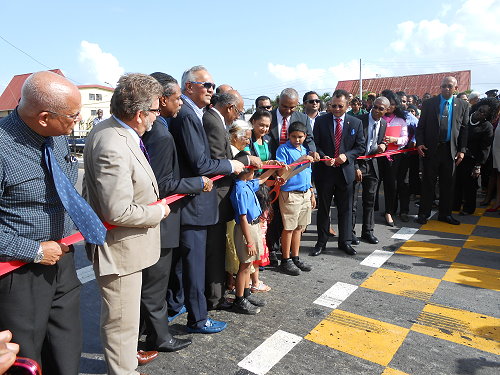 Prime Minister Kamla Persad Bissessar cutting the ribbon to declare the new SMR  formally open