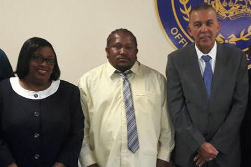 MP Marlene McDonald, Cedric Burke (centre) and President Anthony Carmona