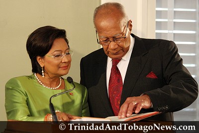 Kamla Persad-Bissessar is sworn in by President George Maxwell Richards as the first female Prime Minister of Trinidad and Tobago