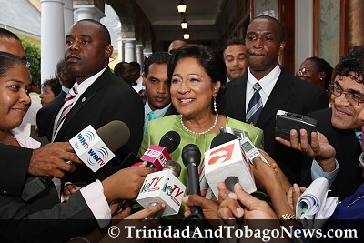 Prime Minister Kamla Persad-Bissessar talks with the media