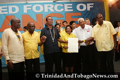 United National Congress (UNC) leader Kamla Persad-Bissessar holds up the Declaration of Political Unity signed at Charlie King Junction, Fyzabad. LEFT: NJAC representative Nyahuma Obika, UNC chairman Jack Warner, chairman of the Movement for Social Justice, Errol McLeod, Congress of the People (COP) political leader Winston Dookeran and Ashworth Jack, leader of the Tobago Organisation of the People (TOP)