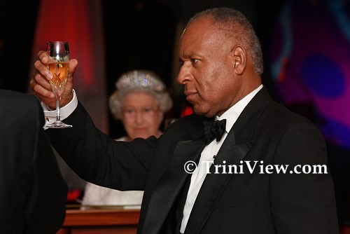 PM Patrick Manning raises his glass (with British Queen in the backdrop) during the State Dinner at President's House for Her Majesty, Queen Elizabeth II