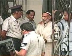 Abdul Kadir being taken from court